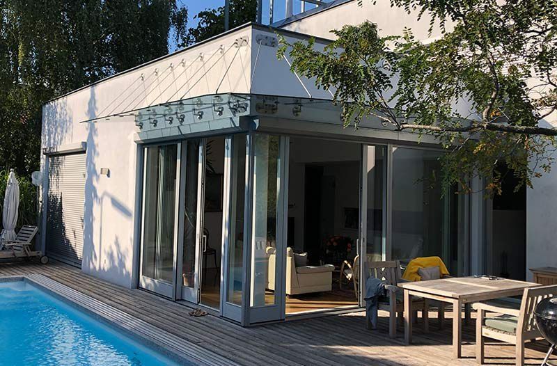 Abgehängtes Nurglas-Vordach an einer großen Garten-Glasfront